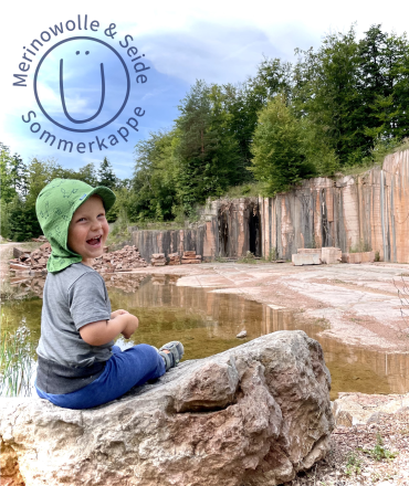 Baby mit Glückskind Sonnenhut – natürlicher UV-Schutz aus Merinowolle